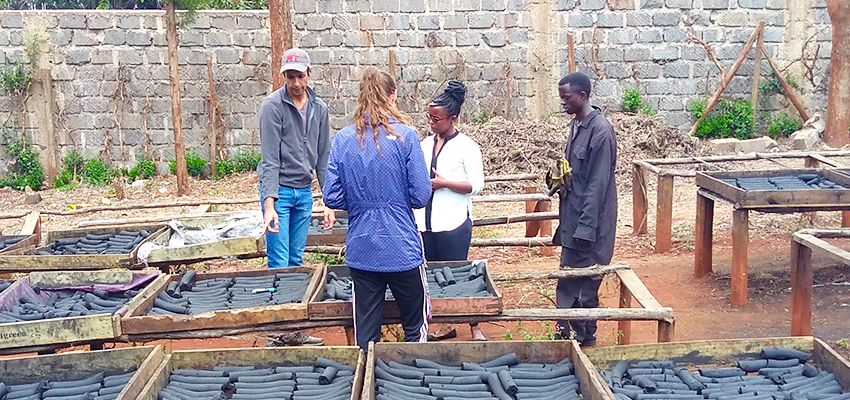 MIT D-Lab trip leader and D-Lab: Energy I instructor Amit Gandhi and blog post author Danielle Gleason discuss sensors with Chebet Lesan, CEO of BrightGreen Renewable Energy, Kenya.” Photo by Jessica Huang.