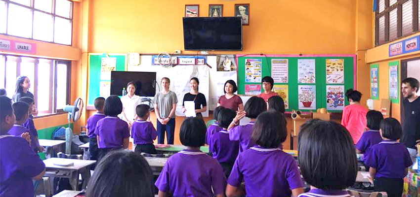 The MIT D-Lab team and a translator greet students at the beginning of class.