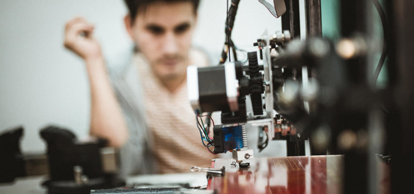 An unaccompanied minor uses a 3D printer during the Digital Design Fabrication Workshop.  © UNHCR/Achilleas Zavallis