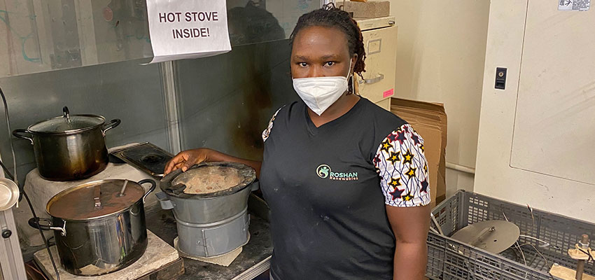 Happy Amos, founder of Roshan Renewables, working in MIT D-Lab's Burn Lab, a fuel and cookstove testing facility. Photo: MIT D-Lab