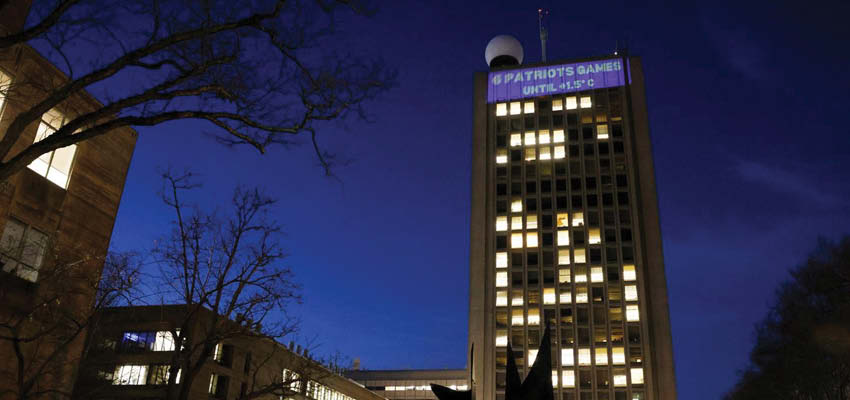 MIT students projected a climate clock onto the university's Green Building. The clock counts down to the projected time that Earth will have warmed 1.5 degrees Celsius from preindustrial levels using unconventional metrics like Boston sporting events. Photo: Jessica Rinaldi/Globe Staff