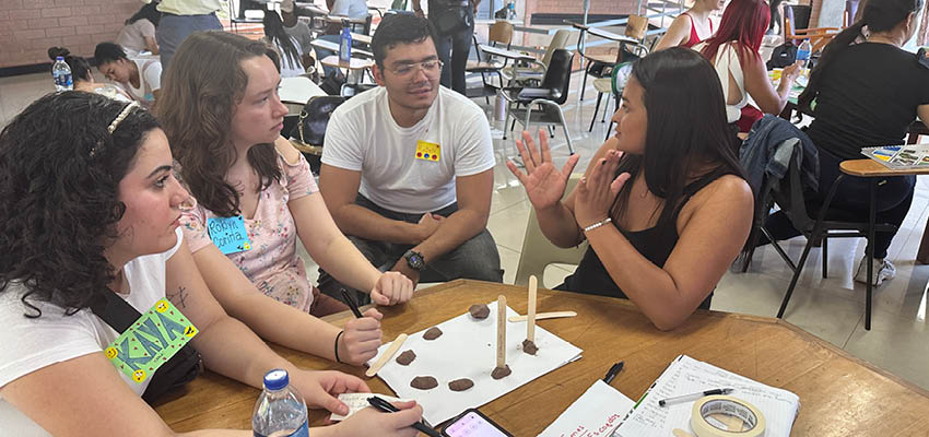 MIT students and women miners co-creating birdcage(s) together