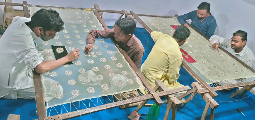 Artisans embroidering