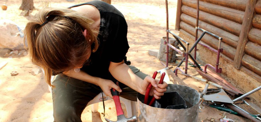 Asli ‘19 shaping a prototype of the rocket stove.