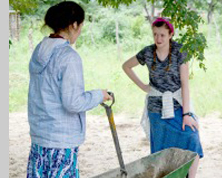 Mina '17 and Shannon '19 mixing cement for the forge.