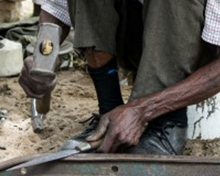 Michael the blacksmith forging a knife on his traditional forge.