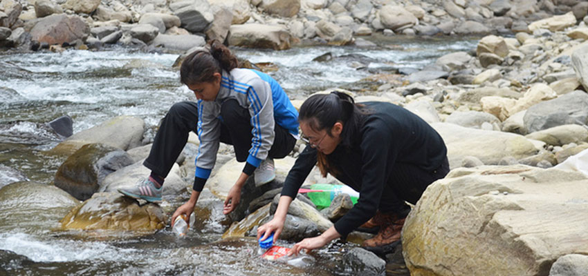 Jackie and Shanta washing plastic bottles by the river, which was a 45 minute drive from the Solambu Hospital where we were staying.